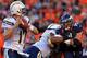 DENVER, CO - NOVEMBER 18: Defensive end Derek Wolfe #95 of the Denver Broncos rushes against the block of tackle Michael Harris #79 of the San Diego Chargers in pursuit of quarterback Philip Rivers #17 of the San Diego Chargers at Sports Authority Field