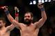 Mar 16, 2013; Montreal, Quebec, CAN; Johny Hendricks (blue) celebrates after his main card bout against Carlos Condit (red) at UFC 158 at the Bell Centre. Mandatory Credit: Eric Bolte-USA TODAY Sports