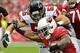 Oct 27, 2013; Phoenix, AZ, USA; Arizona Cardinals running back Andre Ellington (38) tires to break a tackle from Atlanta Falcons outside linebacker Paul Worrilow (55) during the first half at University of Phoenix Stadium. Mandatory Credit: Matt Kartozian