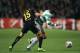 GLASGOW, SCOTLAND - OCTOBER 01: Giorgos Samaras of Celtic takes on Marc Bartra of Barcelona during the UEFA Champions League Group H match between Celtic and FC Barcelona at Celtic Park Stadium on October 1, 2013 in Glasgow, Scotland. (Photo by Richard