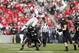 WEST LAFAYETTE, IN - NOVEMBER 2: Carlos Hyde #34 of the Ohio State Buckeyes tries to jump over Frankie Williams #24 of the Purdue Boilermakers while running with the ball during the first half of the game at Ross-Ade Stadium on November 2, 2013 in West La