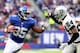 EAST RUTHERFORD, NJ - NOVEMBER 10: Andre Brown #35 of the New York Giants carries the ball as Charles Woodson #24 of the Oakland Raiders defends at MetLife Stadium on November 10, 2013 in East Rutherford, New Jersey.The New York Giants defeated the Oakla