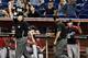 MIAMI, FL - SEPTEMBER 07: Umpires get together on the field and signal for a fair home run after viewing a replay of a two run home run by Ryan Zimmerman #11 of the Washington Nationals as Manager Davey Johnson (R) gestures against the Miami Marlins duri