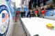 NEW YORK, NY - OCTOBER 29: A guest participates in a curling demo during the USOC 100 Days Out 2014 Sochi Winter Olympics Celebration at Times Square on October 29, 2013 in New York City. (Photo by D Dipasupil/Getty Images for USOC)