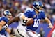 EAST RUTHERFORD, NJ - NOVEMBER 10: Eli Manning #10 of the New York Giants scrambles against the Oakland Raiders in the fourth quarter at MetLife Stadium on November 10, 2013 in East Rutherford, New Jersey.The New York Giants defeated the Oakland Raiders