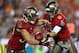 TAMPA, FL - NOVEMBER 11: Mike Glennon #8 of the Tampa Bay Buccaneers hands off to Brian Leonard #30 during a game against the Miami Dolphins at Raymond James Stadium on November 11, 2013 in Tampa, Florida. (Photo by Mike Ehrmann/Getty Images)