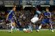 LONDON, ENGLAND - AUGUST 21: Christian Benteke of Aston Villa shoots past John Terry of Chelsea to score a goal to level the scores at 1-1 during the Barclays Premier League match between Chelsea and Aston Villa at Stamford Bridge on August 21, 2013 in L