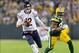 Nov 4, 2013; Green Bay, WI, USA; Chicago Bears quarterback Josh McCown (12) rushes with the football in front of Green Bay Packers defensive end C.J. Wilson (98) during the second quarter at Lambeau Field. Mandatory Credit: Jeff Hanisch-USA TODAY Sports