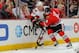 CHICAGO, IL - OCTOBER 29: Chris Neil #25 of the Ottawa Senators and Nick Leddy #8 of the Chicago Blackhawks chase after the puck during the NHL game on October 29, 2013 at the United Center in Chicago, Illinois. (Photo by Bill Smith/NHLI via Getty Images)