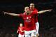 MANCHESTER, UNITED KINGDOM - MARCH 11: Nemanja Vidic of Manchester United celebrates scoring the opening goal with team mate Rio Ferdinand (R) during the UEFA Champions League Round of Sixteen, Second Leg match between Manchester United and Inter Milan a