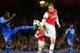 LONDON, ENGLAND - OCTOBER 29: Nicklas Bendtner of Arsenal beats Michael Essien of Chelsea to the ball during the Capital One Cup Fourth Round match between Arsenal and Chelsea at the Emirates Stadium on October 29, 2013 in London, England. (Photo by Jami