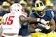 ANN ARBOR, MI - NOVEMBER 09: Michael Rose #15 of the Nebraska Cornhuskers tries to arm tackle Fitzgerald Toussaint #28 of the Michigan Wolverines in the third quarter at Michigan Stadium on November 9, 2013 in Ann Arbor, Michigan. (Photo by Gregory Sham