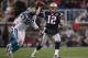 FOXBORO, MA - DECEMBER 13: Tom Brady #12 of the New England Patriots attempts to throw a pass under pressure from Julius Peppers #90 of the Carolina Panthers during a game against the New England Patriots at Gillette Stadium on December 13, 2009 in Foxb