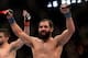 Mar 16, 2013; Montreal, Quebec, CAN; Johny Hendricks (blue) celebrates after his main card bout against Carlos Condit (red) at UFC 158 at the Bell Centre. Mandatory Credit: Eric Bolte-USA TODAY Sports