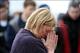 January 22, 2012; State College, PA, USA; A fan of the Penn State Nittany Lions prays at a makeshift memorial for former head coach Joe Paterno outside Beaver Stadium. Mandatory Credit: Rob Christy-USA TODAY Sports