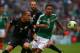 MEXICO CITY, MEXICO - NOVEMBER 13: Jesus Escoboza of Mexico struggles for the ball with Leo Bertos of New Zealand during a match between Mexico and New Zealand as part of the FIFA World Cup Qualifiers at Azteca Stadium on November 13, 2013 in Mexico City,