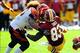 September 23, 2012; Landover, MD, USA; Washington Redskins tight end Fred Davis (83) loses his helmet after being hit by Cincinnati Bengals linebacker Rey Maualuga (58) during the fourth quarter at FedEx Field. The Bengals defeated the Redskins 38-31. Man