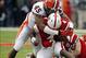 Oct 5, 2013; Lincoln, NE, USA; Illinois Fighting Illini Jonathon Brown (45) tackles Nebraska Cornhuskers quarterback Tommy Armstrong Jr. (4) during the second quarter at Memorial Stadium. Nebraska won 39-19. Mandatory Credit: Bruce Thorson-USA TODAY Sport