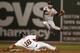 BOSTON, MA - SEPTEMBER 18: J.J. Hardy #2 of the Baltimore Orioles leaps over sliding Will Middlebrooks #16 of the Boston Red Sox to turn a double play during the eleventh inning of the game at Fenway Park on September 18, 2013 in Boston, Massachusetts.