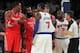 Nov 14, 2013; New York, NY, USA; New York Knicks small forward Carmelo Anthony (7) is restrained by official Scott Foster (48) as he confronts Houston Rockets power forward Dwight Howard (12) and shooting guard James Harden (13) during the third quarter o