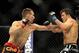 Jul 27, 2013; Seattle, WA, USA; Rory MacDonald (red tape) lands a punch to the mid-section of Jake Ellenberger (blue tape) during their welterweight bout at Key Arena. McDonald won by a decision. Mandatory Credit: Jayne Kamin-Oncea-USA TODAY Sports