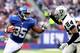 EAST RUTHERFORD, NJ - NOVEMBER 10: Andre Brown #35 of the New York Giants carries the ball as Charles Woodson #24 of the Oakland Raiders defends at MetLife Stadium on November 10, 2013 in East Rutherford, New Jersey.The New York Giants defeated the Oakla