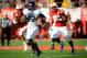 LINCOLN, NE - NOVEMBER 2: Running back Treyvon Green #22 of the Northwestern Wildcats storms through the Nebraska Cornhuskers defense during their game at Memorial Stadium on November 2, 2013 in Lincoln, Nebraska. (Photo by Eric Francis/Getty Images)