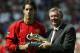 MANCHESTER, ENGLAND - AUGUST 16: Ruud Van Nistelrooy of Man Utd is presented with the Barclaycard golden boot for last season by Sir Alex Ferguson during the FA Barclaycard Premiership match between Manchester United and Bolton Wanderers at Old Trafford