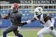 Nov 16, 2013; Lawrence, KS, USA; Kansas Jayhawks quarterback Montell Cozart (2) is chased out of bounds by West Virginia Mountaineers linebacker Isaiah Bruce (31) in the first half at Memorial Stadium. Mandatory Credit: John Rieger-USA TODAY Sports