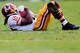 PHILADELPHIA, PA - NOVEMBER 17: Quarterback Robert Griffin III #10 of the Washington Redskins holds onto the ball after being tackled rushing for a gain against the Philadelphia Eagles during the first half at Lincoln Financial Field on November 17, 2013