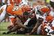 Nov 17, 2013; Cincinnati, OH, USA; Cleveland Browns running back Willis McGahee (26) is tackled by Cincinnati Bengals defensive end Carlos Dunlap (96) during the game at Paul Brown Stadium. Cincinnati won 41-20. Mandatory Credit: Kevin Jairaj-USA TODAY Sp