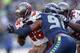 SEATTLE, WA - NOVEMBER 03: Running back Mike James #25 of the Tampa Bay Buccaneers rushes against defensive end Chris Clemons #91 of the Seattle Seahawks at CenturyLink Field on November 3, 2013 in Seattle, Washington. The Seahawks defeated the Buccaneer