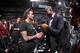 Beckham chatting with retired NBA player turned Dodgers owner Magic Johnson.