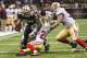 NEW ORLEANS, LA - NOVEMBER 17: Jimmy Graham #80 of the New Orleans Saints is tackled at the five yard line by Carlos Rogers #22 of the San Francisco 49ers at Mercedes-Benz Superdome on November 17, 2013 in New Orleans, Louisiana. The Saints defeated th
