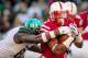 LINCOLN, NE - NOVEMBER 16: Running back Ameer Abdullah #8 of the Nebraska Cornhuskers runs through arms of defensive end Shilique Calhoun #89 of the Michigan State Spartans during their game at Memorial Stadium on November 16, 2013 in Lincoln, Nebraska. (