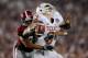 PASADENA, CA - JANUARY 07: Quarterback Garrett Gilbert #3 of the Texas Longhorns fumbles the ball as he is hit by linebacker Eryk Anders #32 of the Alabama Crimson Tide during the Citi BCS National Championship game at the Rose Bowl on January 7, 2010 in