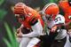 CINCINNATI, OH - NOVEMBER 17: Andy Dalton #14 of the Cincinnati Bengals is sacked from behind by Jabaal Sheard #97 of the Cleveland Browns #97 during the game against the Cleveland Browns at Paul Brown Stadium on November 17, 2013 in Cincinnati, Ohio. T
