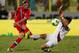 DUBAI, UNITED ARAB EMIRATES - NOVEMBER 19: Dmitry Tarasov (L) of Russia takes a shot at goal in front of Park Jong-Woo (R) of South Korea during the International Football match between South Korea and Russia at the Zabeel Staduim on November 19, 2013 in
