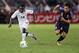 YOKOHAMA, JAPAN - SEPTEMBER 10: Solomon Asante of Ghana is challenged by Yuto Nagatomo of Japan during the international friendly match between Japan and Ghana at International Stadium Yokohama on September 10, 2013 in Yokohama, Japan. (Photo by Adam Pr
