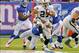 Nov 10, 2013; East Rutherford, NJ, USA; Oakland Raiders running back Rashad Jennings (27) tries to get away from New York Giants outside linebacker Keith Rivers (55) during the first half at MetLife Stadium. Mandatory Credit: Jim O'Connor-USA TODAY Sport