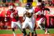 LINCOLN, NE - NOVEMBER 2: Running back Treyvon Green #22 of the Northwestern Wildcats runs past safety Corey Cooper #6 and defensive end Avery Moss #94 of the Nebraska Cornhuskers during their game at Memorial Stadium on November 2, 2013 in Lincoln, Nebra