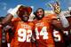 DALLAS, TX - OCTOBER 12: (L-R) Reggie Wilson #92 of the Texas Longhorns and Jackson Jeffcoat #44 of the Texas Longhorns celebrate with the game trophy after the Longhorns beat the Sooners 36-20 at the Cotton Bowl on October 12, 2013 in Dallas, Texas. (P