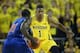 ANN ARBOR, MI - NOVEMBER 08: Glenn Robinson III #1 of the Michigan Wolverines defends against Akeem Williams #11 of the Massachusetts Lowell River Hawks during the second half of the game at Crisler Center on November 8, 2013 in Ann Arbor, Michigan. Michi