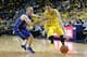 ANN ARBOR, MI - NOVEMBER 08: Mark Cornelius #30 of the Massachusetts Lowell River Hawks defends Nik Stauskas #11 of the Michigan Wolverines during the first half of the game at Crisler Center on November 8, 2013 in Ann Arbor, Michigan. Michigan defeated U