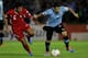 MONTEVIDEO, URUGUAY - NOVEMBER 20: Luis Suarez (R) of Uruguay fights for the ball with Tareq Khattab (L) of Jordan during leg 2 of the FIFA World Cup Qualifier match between Uruguay and Jordan at Centenario Stadium Stadium on November 20, 2013 in Montevi