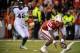 LINCOLN, NE - NOVEMBER 16: Quarterback Tommy Armstrong Jr. #4 of the Nebraska Cornhuskers picks up his fumble in front of defensive end Denzel Drone #42 of the Michigan State Spartans during their game at Memorial Stadium on November 16, 2013 in Lincoln,