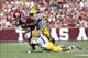 Oct 20, 2012; College Station, TX, USA; Texas A&M Aggies quarterback Johnny Manziel (2) is tackled by LSU Tigers linebacker Lamin Barrow (57) and safety Eric Reid (1) in the first quarter at Kyle Field. Mandatory Credit: Brett Davis-USA TODAY Sports