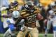 Nov 17, 2013; Pittsburgh, PA, USA; Pittsburgh Steelers running back Le'Veon Bell (26) runs the ball past Detroit Lions defensive end Willie Young (79) during the first half at Heinz Field. Mandatory Credit: Jason Bridge-USA TODAY Sports