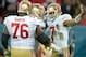 Oct 27, 2013; London, United Kingdom; San Francisco 49ers quarterback Colin Kaepernick (7) celebrates with tackle Anthony Davis (76) and guard Mike Iupati (77) after scoring a touchdown against the Jacksonville Jaguars in the NFL International Series game