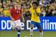 Nov 19, 2013; Toronto, Ontario, Canada; Brazil forward Willian (9) takes the ball up field as Chile forward Carlos Carmona (6) gives chase during the second half in a friendly soccer game at Rogers Centre. Brazil won 2-1. Mandatory Credit: Nick Turchiaro